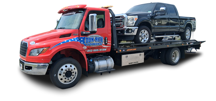 Tow truck with black pickup truck