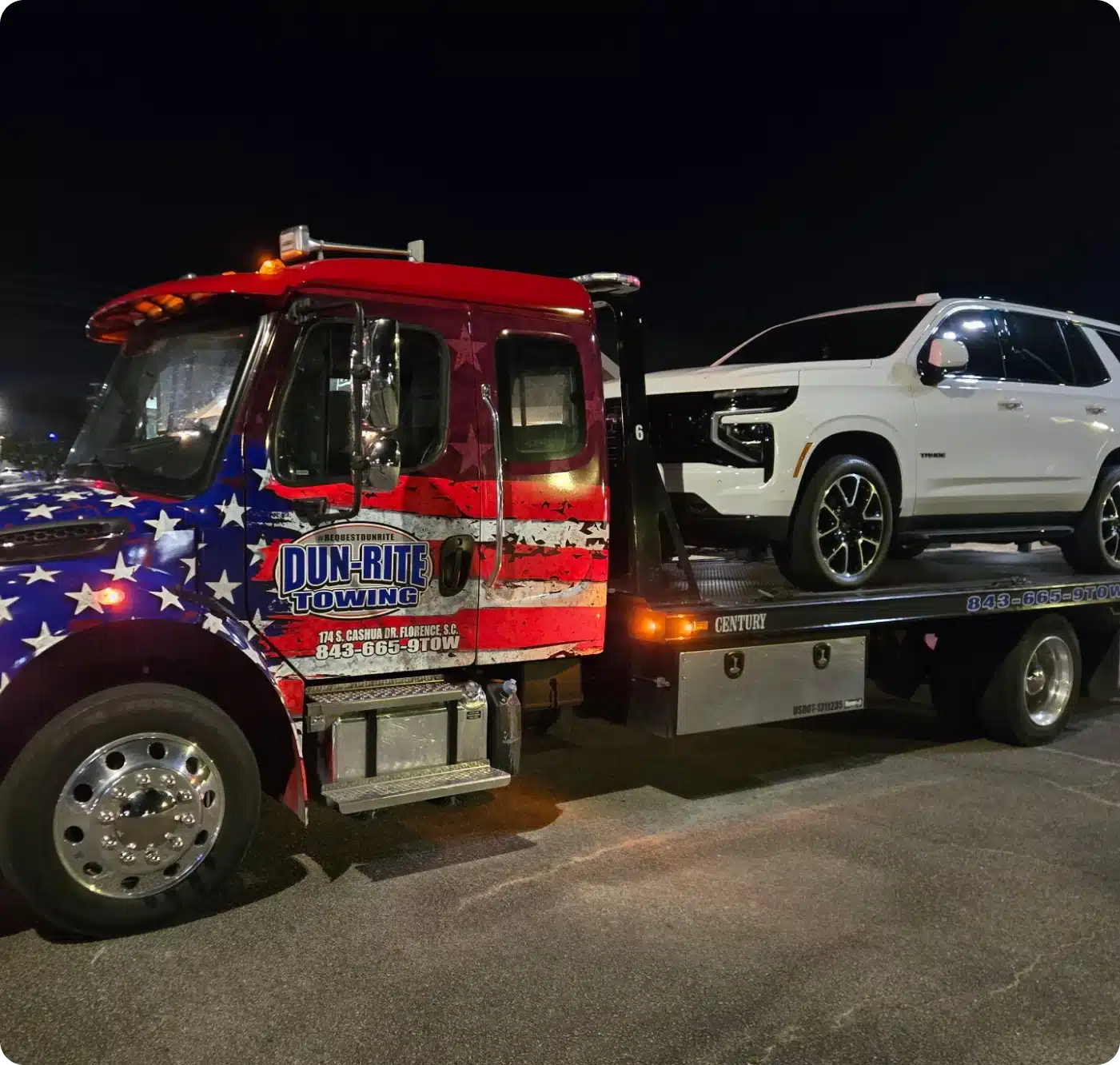 Tow truck with white SUV loaded